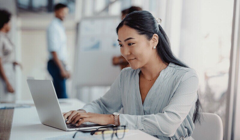 Woman typing on a laptop in the office